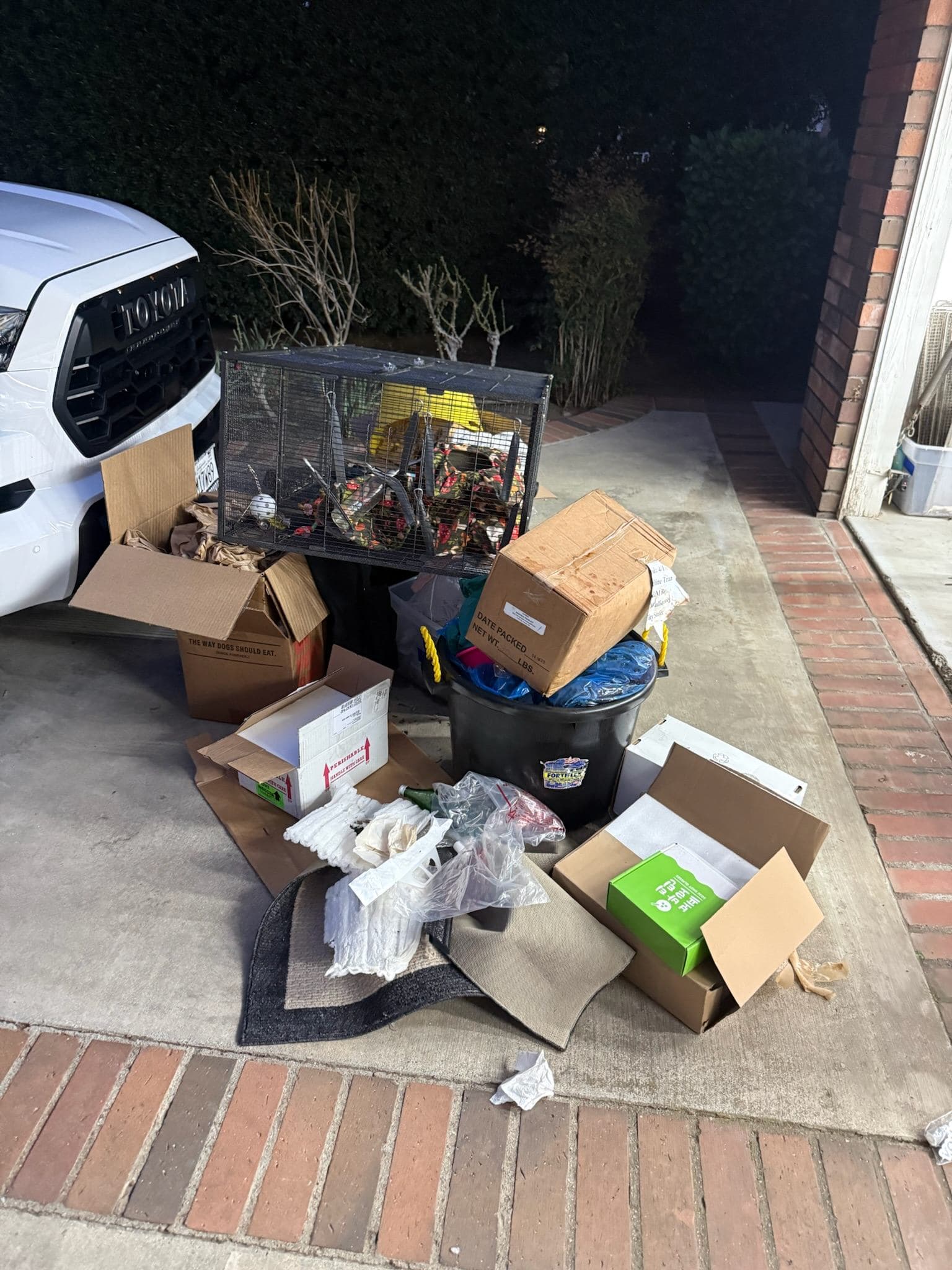 Driveway area with boxes and household items before Wade Home Services cleanout
